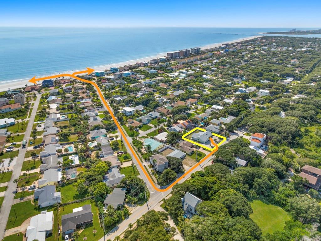 An aerial view shows a coastal neighborhood with a highlighted house and path to the beach — 4715 S PENINSULA DRIVE, PONCE INLET, FL