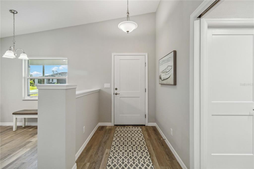 A single-story house with a gray garage door and a paved driveway — 6316 DEER RUN RD, NORTH PORT, FL