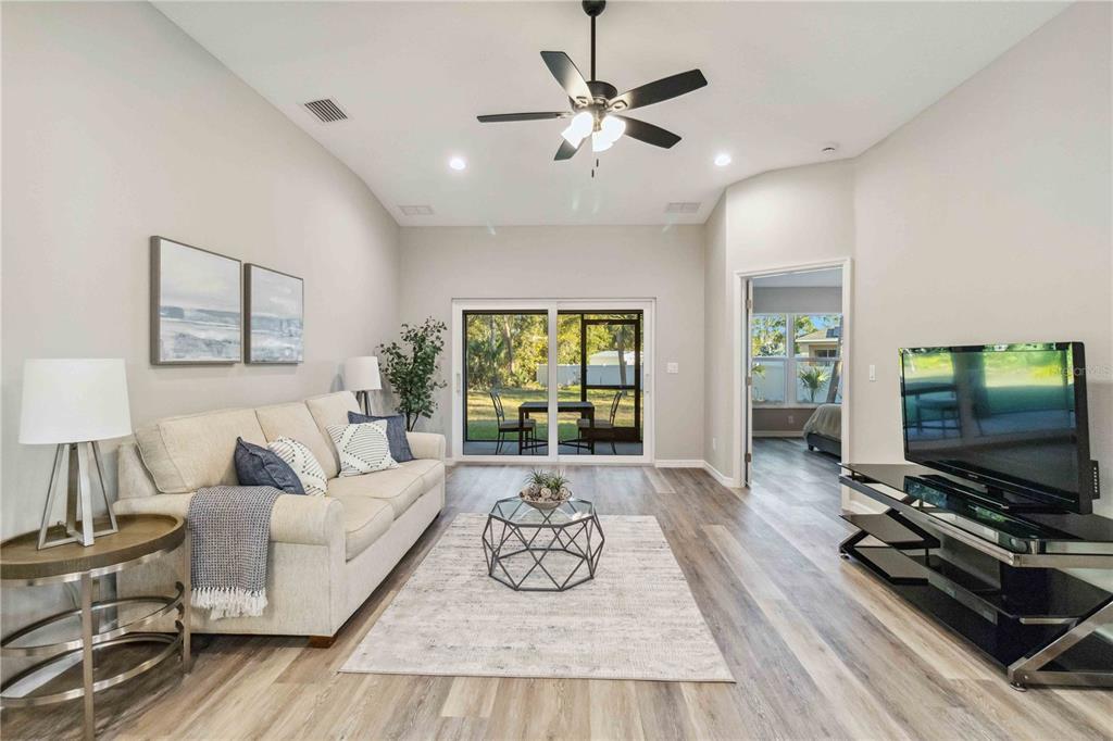 A single-story house with a gray garage, light-colored stucco exterior, and a paved driveway — 6316 DEER RUN RD, NORTH PORT, FL
