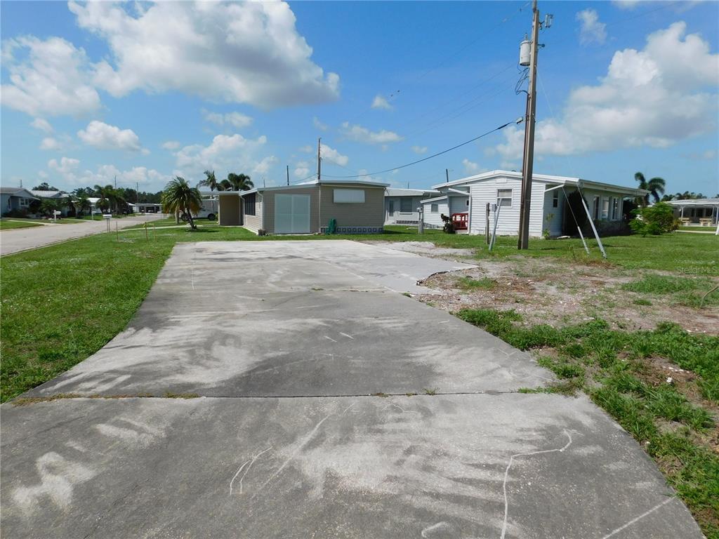 A concrete driveway leads to an empty lot in a mobile home community — 1205 43RD AVENUE DRIVE E, ELLENTON, FL
