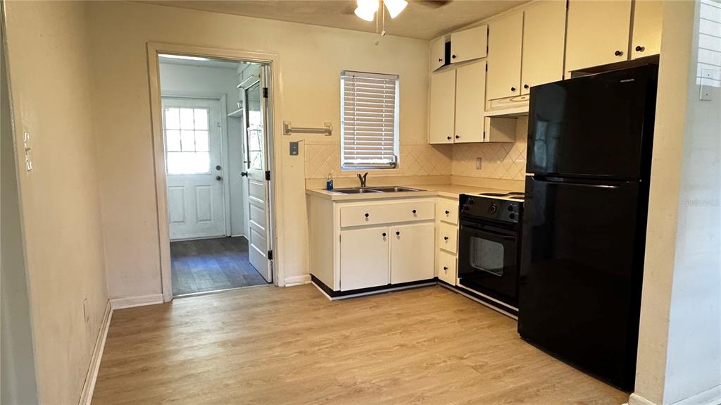 A sunroom with tile flooring, large windows with brown curtains, and a white ceiling — 4316 SW DEEPWATER COURT, DUNNELLON, FL