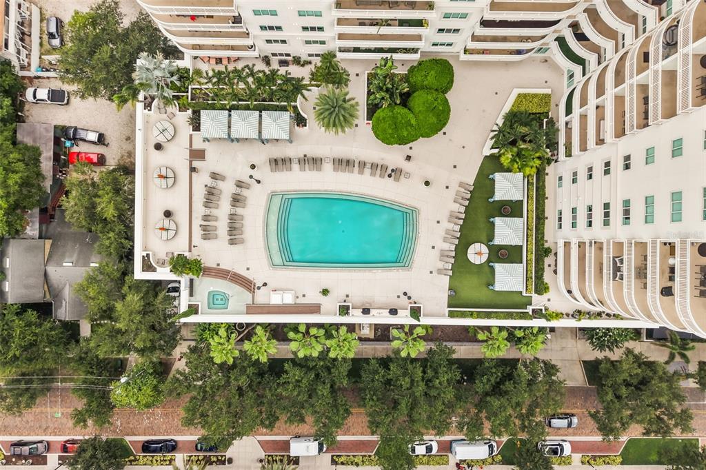 An aerial view shows a swimming pool, hot tub, and lounge area at a residential building — 100 S EOLA DRIVE UNIT 119, ORLANDO, FL