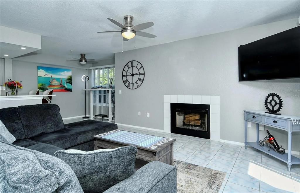 A three-story apartment building with screened balconies and a palm tree in the front yard — 850 S TAMIAMI TRAIL UNIT 801, SARASOTA, FL