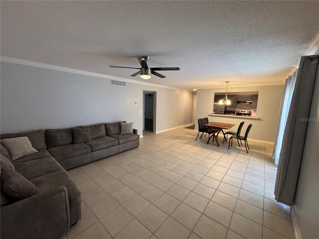 A kitchen features dark gray cabinets, stainless steel appliances, and a white countertop — 1968 TOUCAN WAY UNIT 1404, SARASOTA, FL