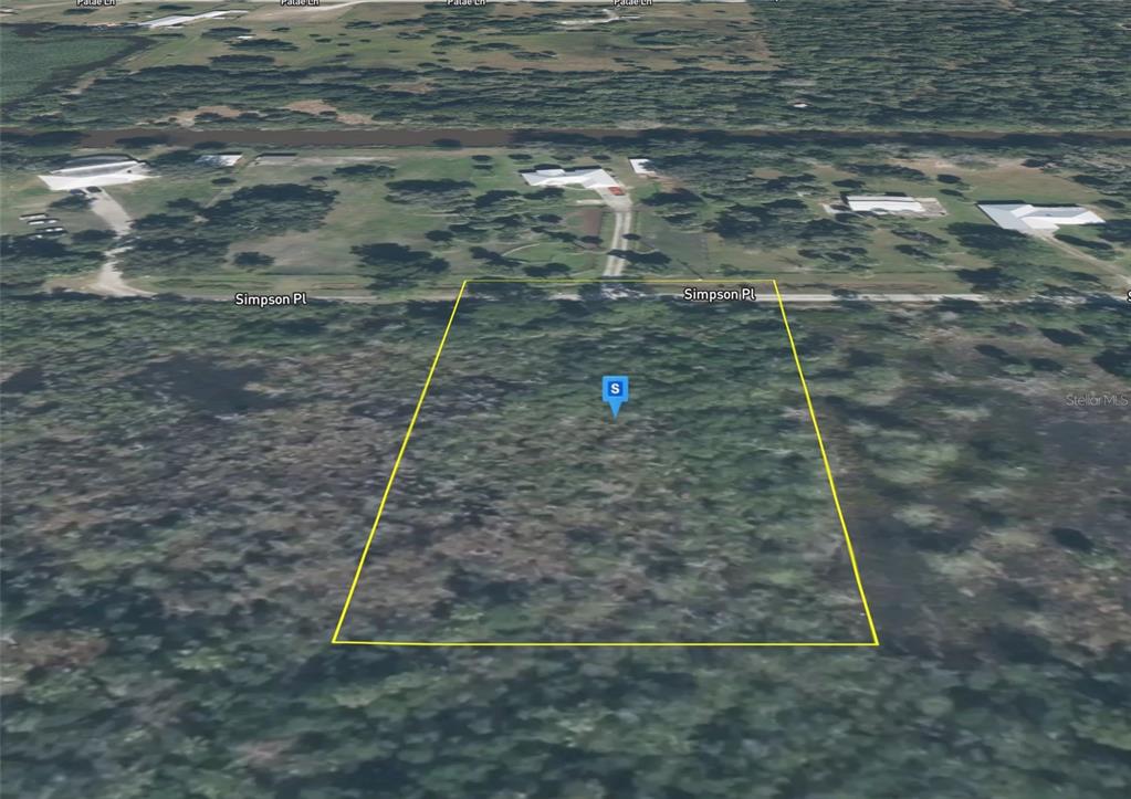An aerial view shows a vacant, rectangular plot of land outlined in yellow on Simpson Place — 5535 SIMPSON PLACE, COCOA, FL