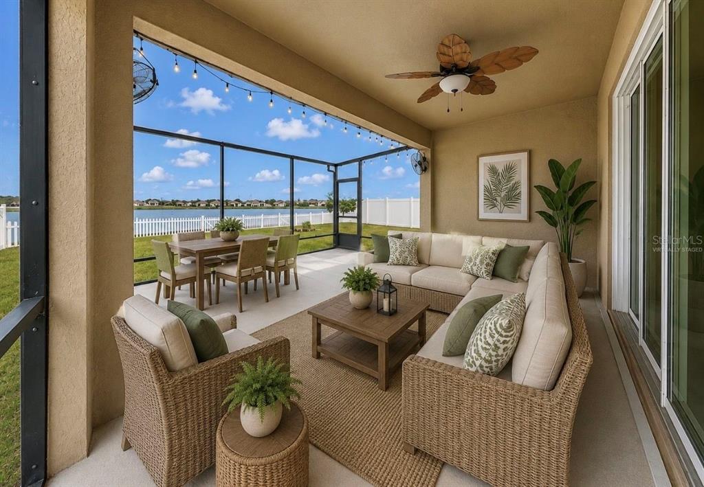 A covered patio with wicker furniture, a dining set, and a view of a lake — 619 WABASH BREEZE CIRCLE, RUSKIN, FL