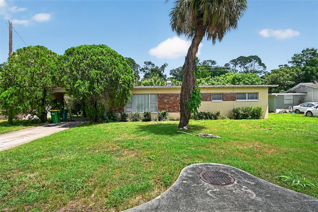 A single-story house with a brick and stucco exterior sits behind a large front lawn — 120 POLARIS STREET, COCOA, FL