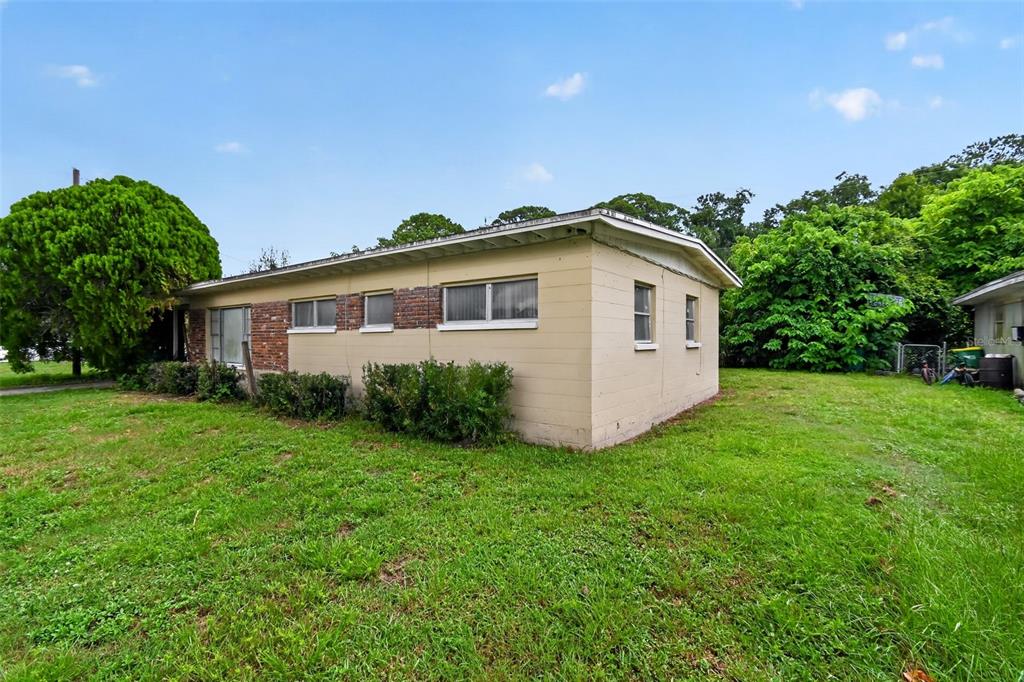 A single-story house with tan siding and brick accents sits on a grassy lot — 120 POLARIS STREET, COCOA, FL