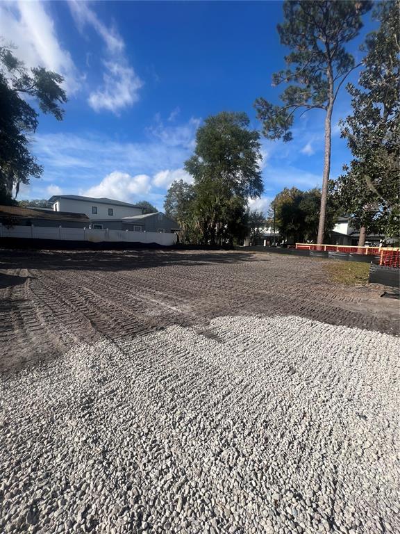 A cleared, level residential lot features a gravel base in the foreground and surrounding trees — 731 MIDGET DRIVE, WINTER PARK, FL