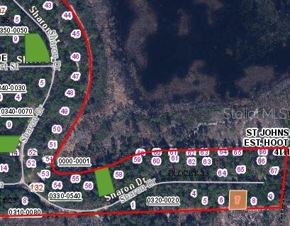 This is an aerial map showing residential lots and street layouts in a wooded area — 153 SHARON DRIVE, SATSUMA, FL