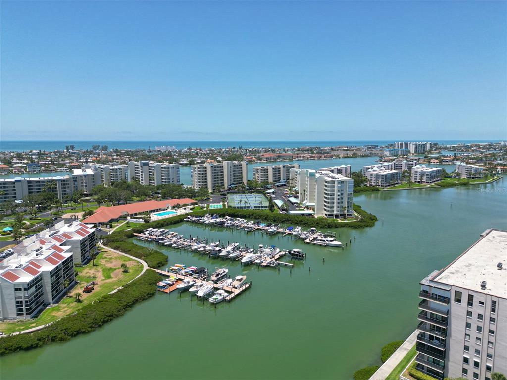 An aerial view of a multi-story apartment building with a red circle highlighting a balcony — 7400 SUN ISLAND DRIVE S UNIT 501, SOUTH PASADENA, FL