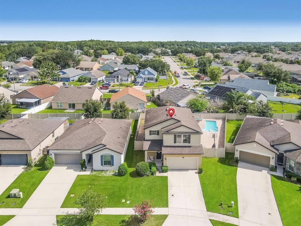 An aerial view of a two-story suburban house with a pool and a fenced backyard — 1833 CAYMAN COVE CIRCLE, ST CLOUD, FL