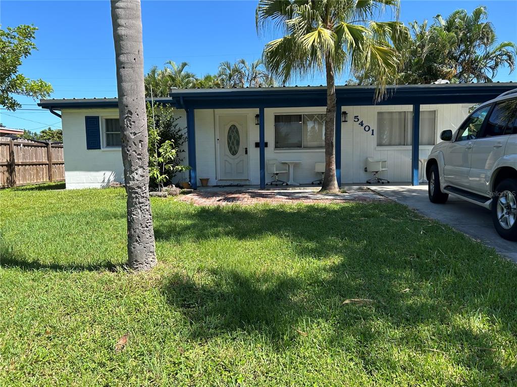 A single-story house with a white exterior, blue trim, and a front porch with chairs — 5401 96TH AVENUE N, PINELLAS PARK, FL