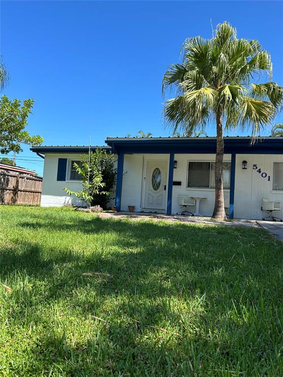 A single-story white house with a blue trim and a palm tree in the yard — 5401 96TH AVENUE N, PINELLAS PARK, FL