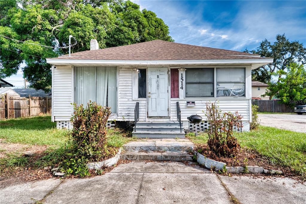A single-story house with white siding, a brown roof, and a small front porch — 1514 12TH AVENUE W, BRADENTON, FL