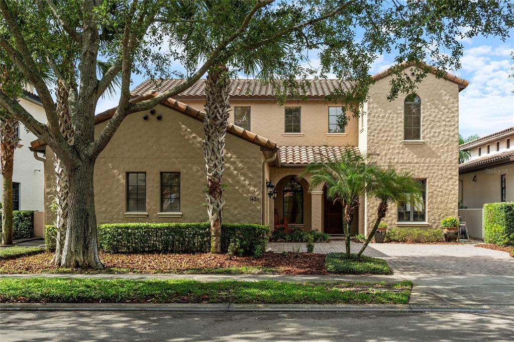 A two-story stucco house with a tile roof and a paved driveway — 1421 CHAPMAN CIRCLE, WINTER PARK, FL