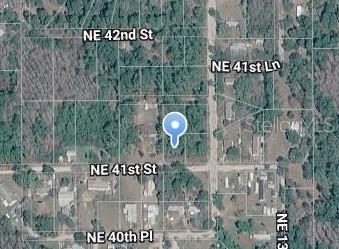 This is an aerial map showing a vacant lot marked with a blue location pin — 00 NE 41ST, SILVER SPRINGS, FL