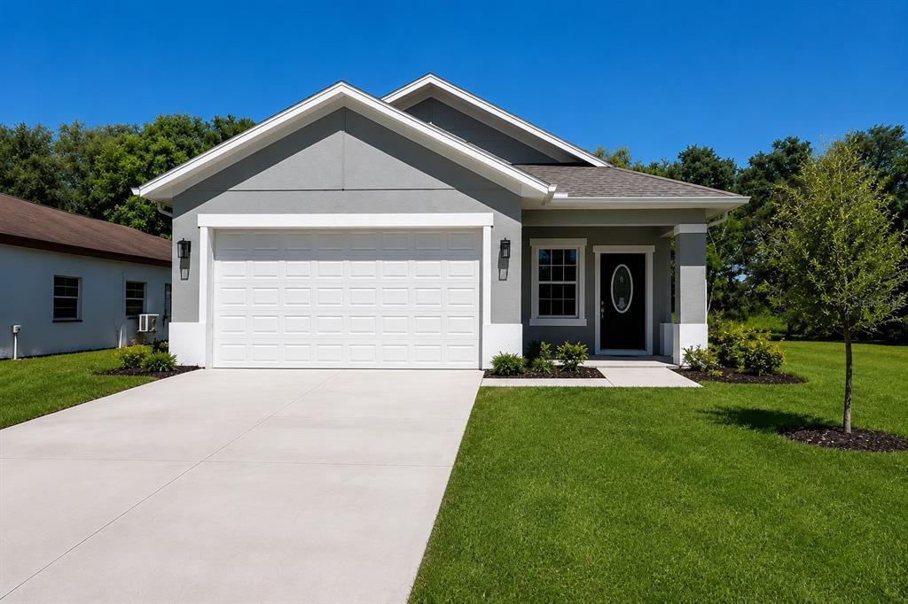 A gray single-story house with a white garage door, a front porch, and a lawn — 125 PINE STREET, ORLANDO, FL