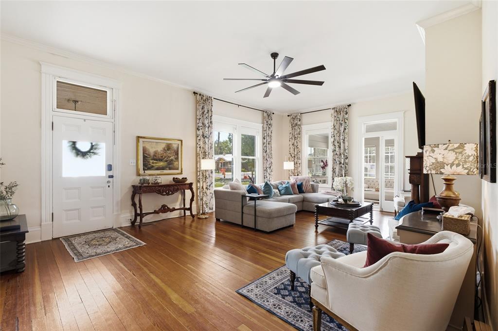 A living room features hardwood floors, a ceiling fan, a sectional sofa, and a front door — 524 E MAGNOLIA STREET, ARCADIA, FL