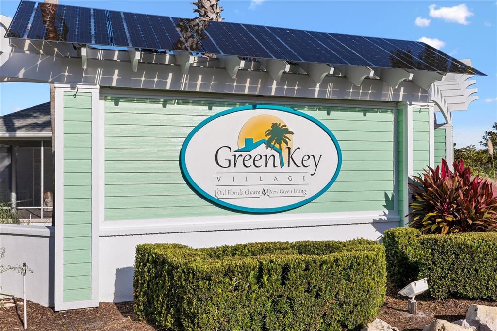 A sign for Green Key Village features solar panels mounted on a pergola above it — 1052 SUGAR LOAF KEY LOOP, LADY LAKE, FL