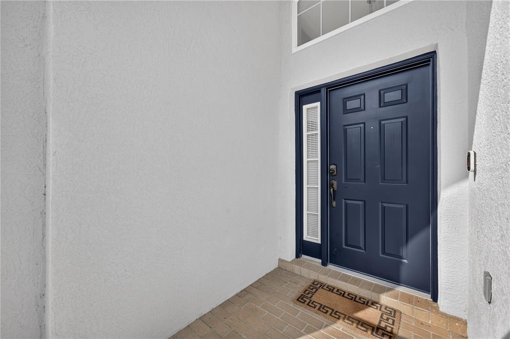 A single-story gray house with a two-car garage and a concrete driveway — 213 SPANISH MOSS ROAD, DAVENPORT, FL