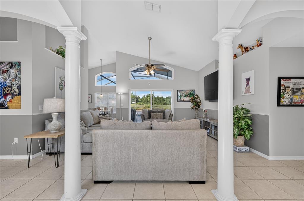 A dark blue front door with a side window sits on a tiled porch — 213 SPANISH MOSS ROAD, DAVENPORT, FL