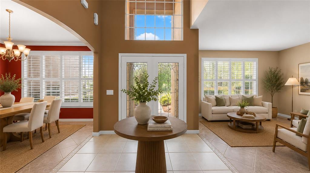 A front entryway features double glass-paneled doors, a tiled porch, and stone-accented exterior walls — 1620 MARINA LAKE DR, KISSIMMEE, FL