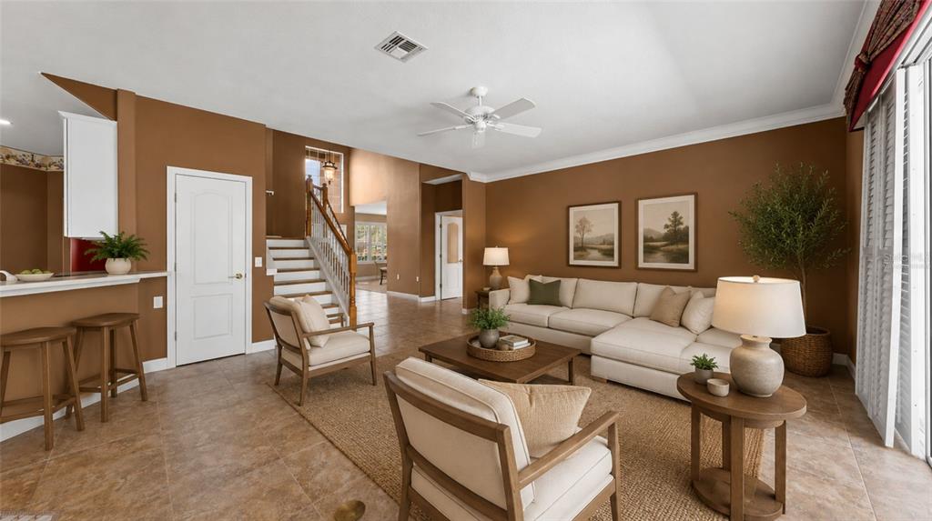 A bright foyer features a round pedestal table, tiled floors, and a double front door — 1620 MARINA LAKE DR, KISSIMMEE, FL
