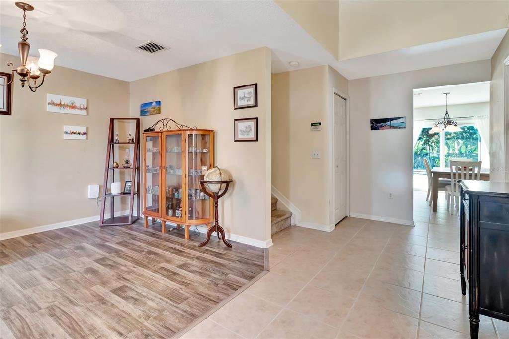A living room with wood flooring, a leather sectional, a recliner, and a television console — 4540 SE 30TH STREET, OCALA, FL