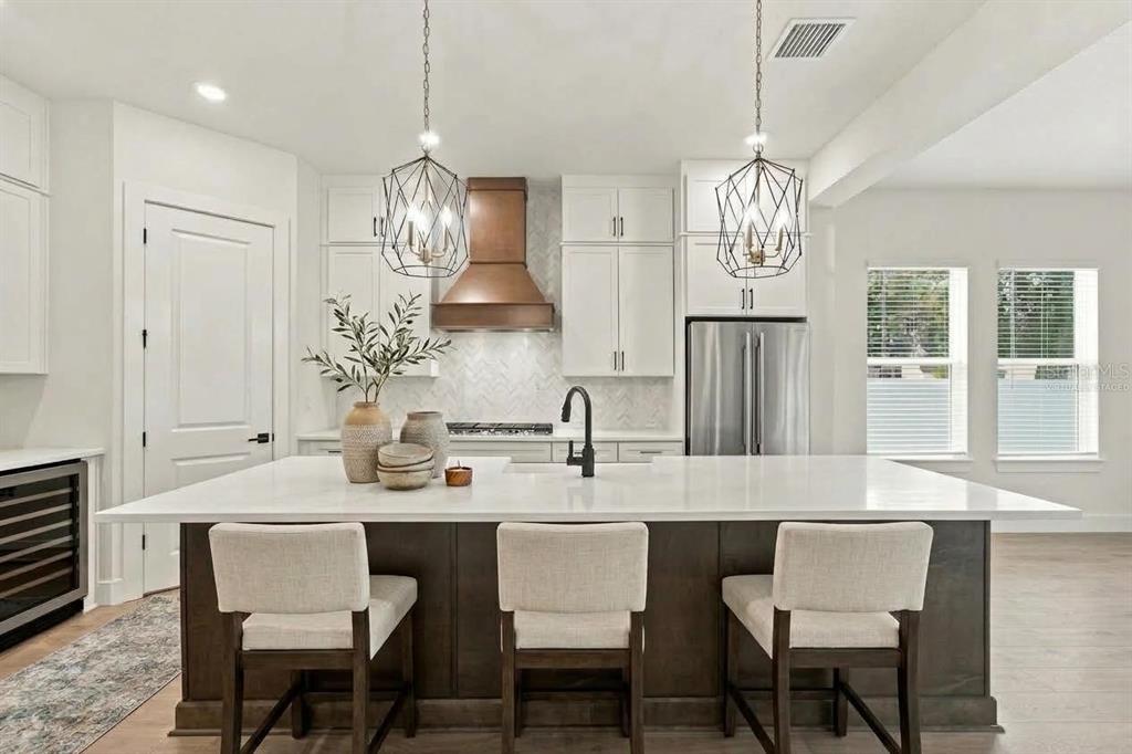 This design board displays kitchen finishes including cabinetry, countertops, flooring, hardware, and lighting fixtures — 812 W ORIENT STREET, TAMPA, FL