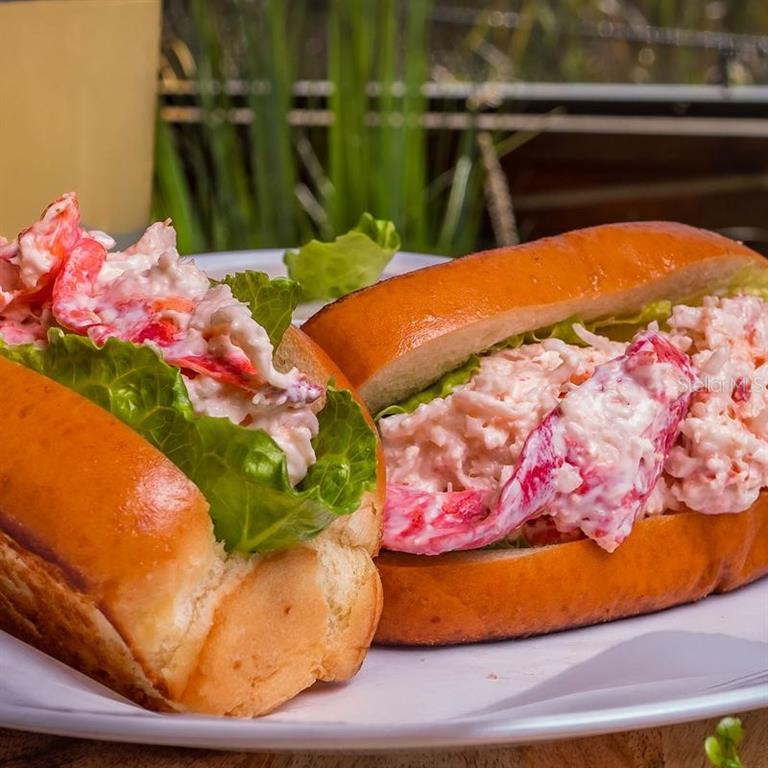 Two lobster rolls served on a white plate with lettuce and creamy seafood salad — 18421 US-41, LUTZ, FL