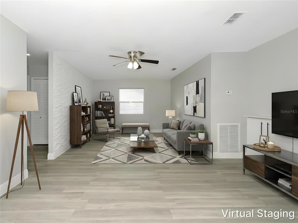 An aerial view of a single-story house with a light blue exterior and gray roof — 919 SYLVIA DRIVE, DELTONA, FL