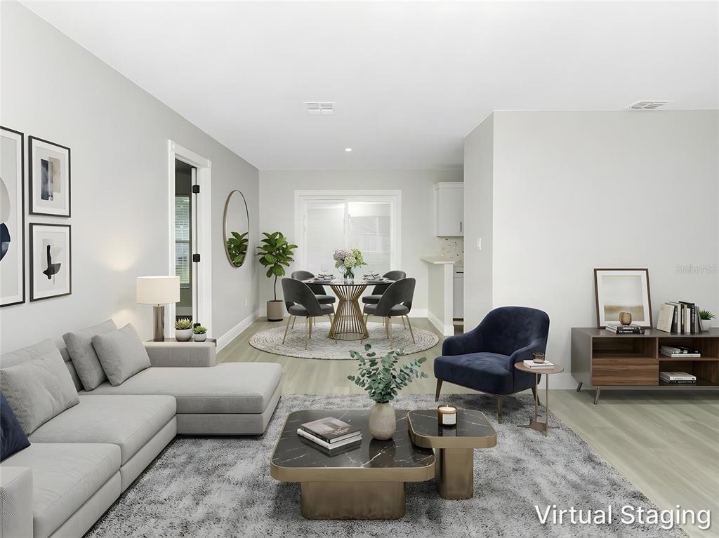 A room with light gray walls, wood-look flooring, a ceiling fan, and white cabinetry — 919 SYLVIA DRIVE, DELTONA, FL