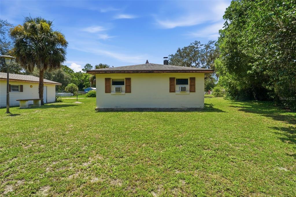 A single-story house with a light-colored exterior and brown shutters sits on a grassy lot — 45828 DEER STREET, PAISLEY, FL
