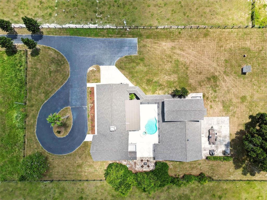 An aerial view shows a house with a pool, a circular driveway, and surrounding land — 1960 SE 150TH STREET, SUMMERFIELD, FL