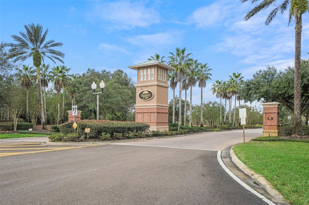 An aerial view shows several suburban houses situated along a golf course and wooded area — 17807 GARSALASO CIRCLE, BROOKSVILLE, FL