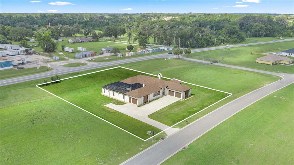 An aerial view shows a single-story house with a screened pool and attached garage — 1866 NW 79TH LOOP, OCALA, FL