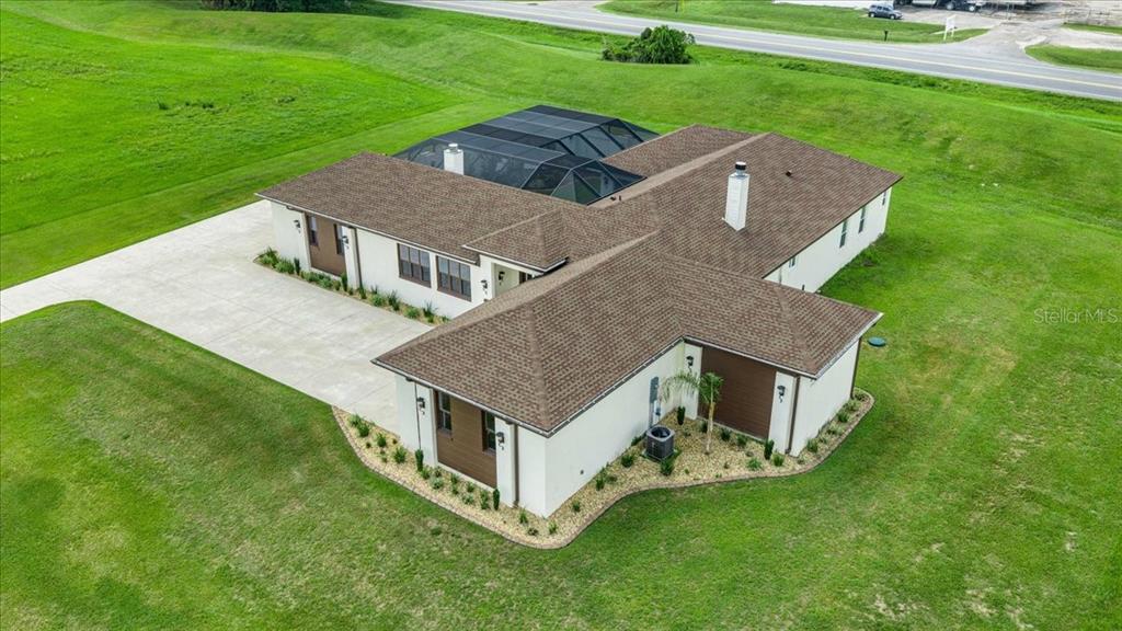 An aerial view shows a single-story house with a screened pool and concrete driveway — 1866 NW 79TH LOOP, OCALA, FL