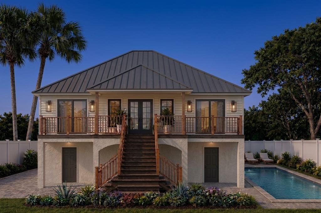A modern white kitchen with a large island overlooks a dining area and waterfront view — 00000 SPOONBILL ROAD E, BRADENTON, FL