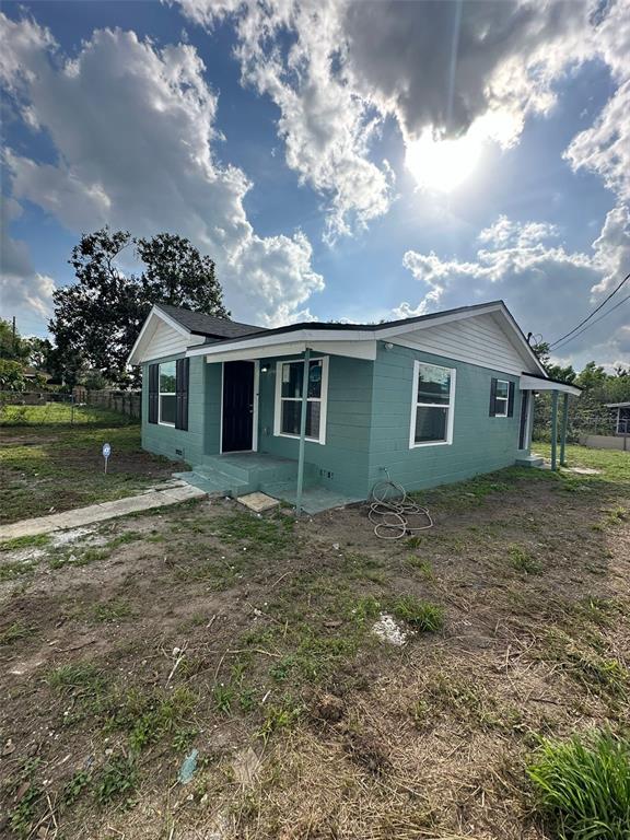 A teal, single-story house with a white roof and a small front porch — 2015 1/2 LAUREL STREET, BARTOW, FL
