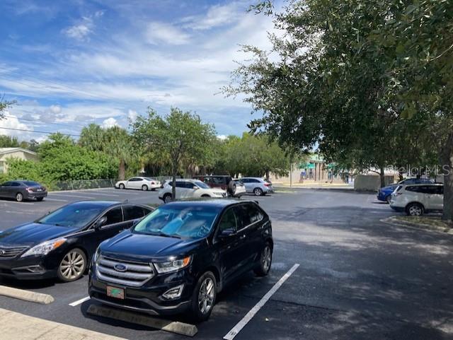 A parking lot with several parked cars under a bright, partly cloudy sky — 4811 W GANDY BOULEVARD UNIT A, TAMPA, FL