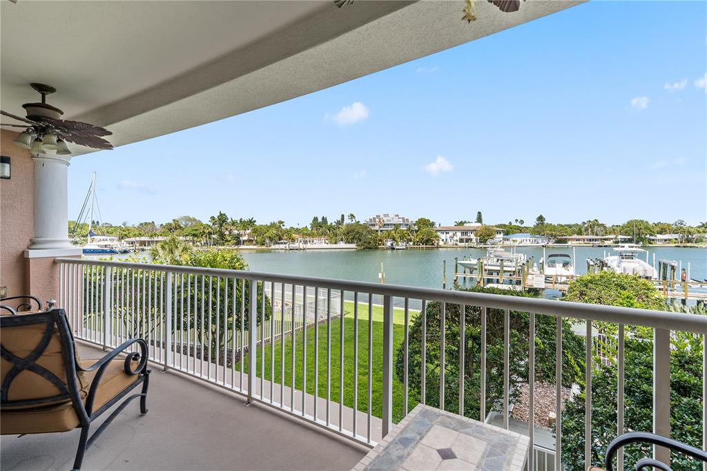An aerial view shows a coastal beach town with a red arrow pointing to a building — 3805 GULF BOULEVARD UNIT 203, ST PETE BEACH, FL
