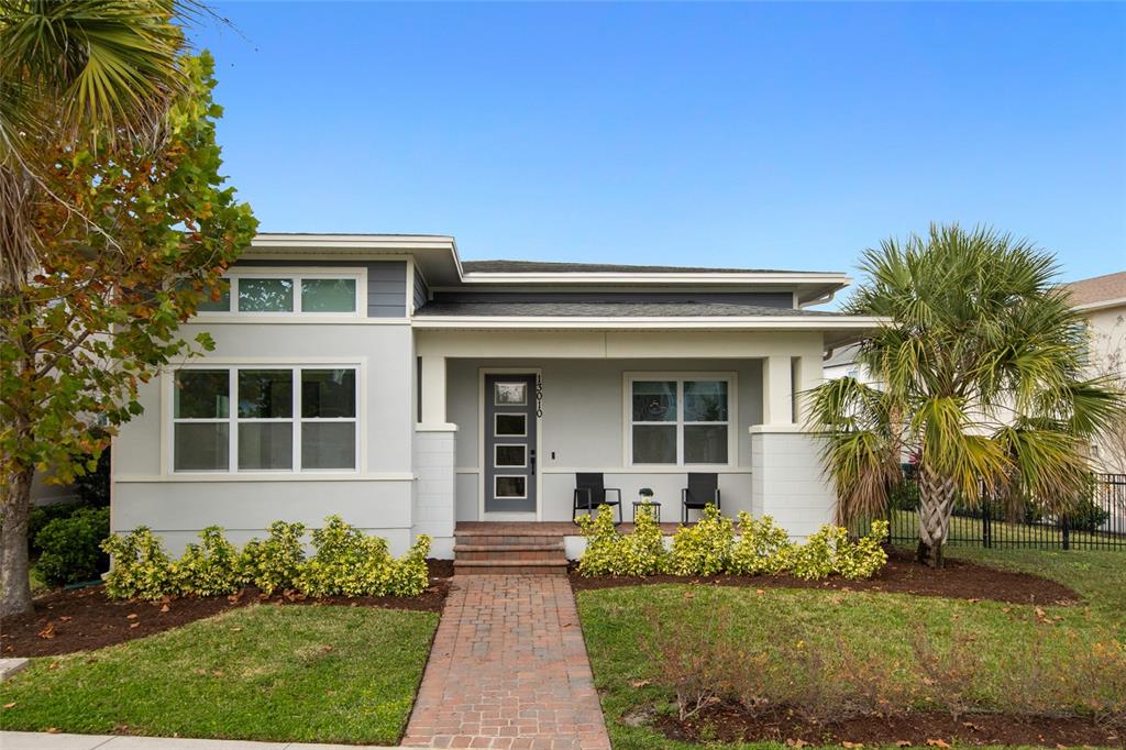 A single-story house with a gray exterior, a brick walkway, and a covered front porch — 13010 STODDART AVENUE, ORLANDO, FL