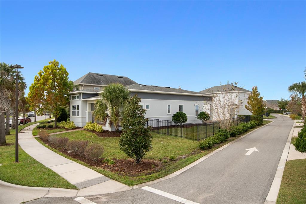 A single-story house with a fenced yard sits at the corner of a paved street — 13010 STODDART AVENUE, ORLANDO, FL