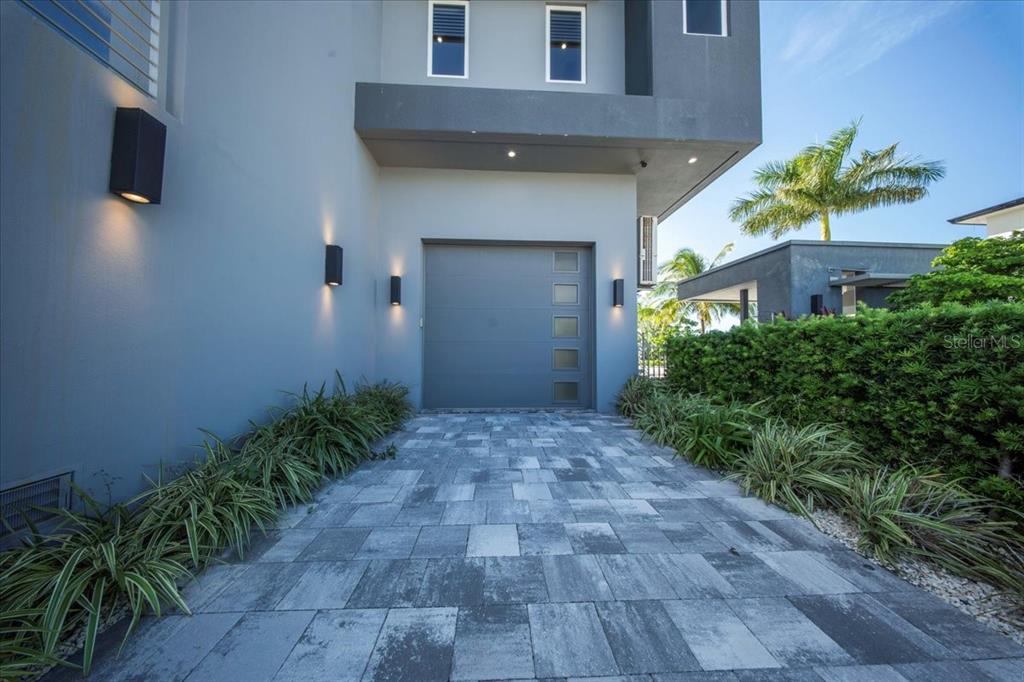 A modern gray house exterior features a single-car garage and a paved driveway — 118 AVENUE E, MARATHON, FL