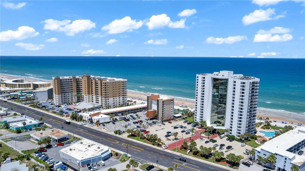 An aerial view shows two large beachfront hotels separated by a road and parking lots — 2425 S ATLANTIC AVENUE UNIT 406, DAYTONA BEACH, FL