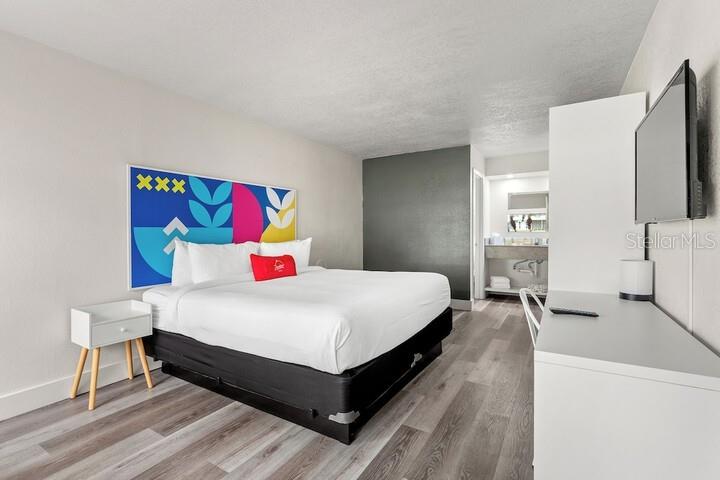 A brightly lit lobby features a reception desk, seating area, and colorful wall murals — 2930 POLYNESIAN ISLE BOULEVARD UNIT 245, KISSIMMEE, FL
