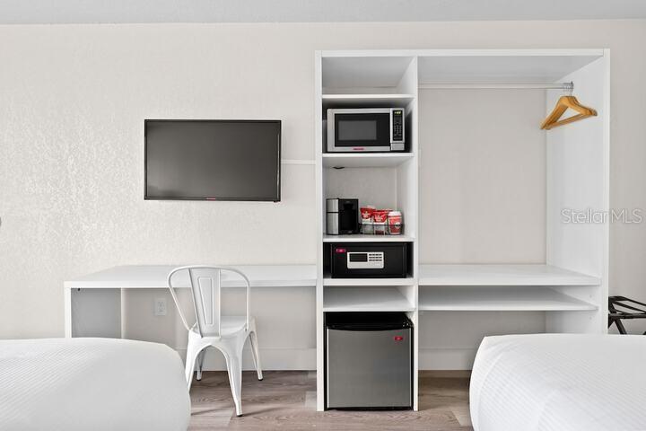 A small market area features two glass-front refrigerators and open shelving stocked with snacks — 2930 POLYNESIAN ISLE BOULEVARD UNIT 245, KISSIMMEE, FL