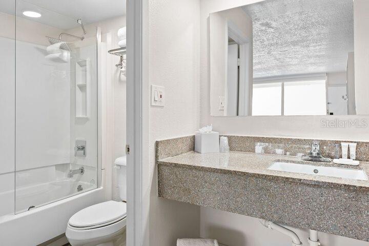 A modern convenience market area features shelving, a refrigerator, and a counter with bar stools — 2930 POLYNESIAN ISLE BOULEVARD UNIT 245, KISSIMMEE, FL