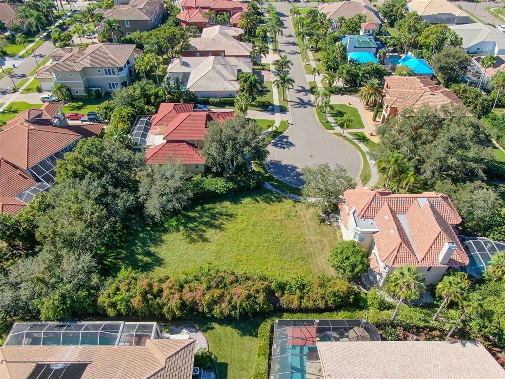 An aerial view shows a vacant residential lot surrounded by houses and mature trees — 5913 LA ROSA LANE, APOLLO BEACH, FL